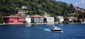 Private boat on sea and so many houses on mountains Royalty Free Stock Photo