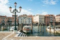 Private boats and taxis moored on Grand Canal in Venice on a bright summer day.