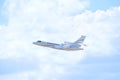 Private business jet airliner plane in flight against fluffy clouds Royalty Free Stock Photo