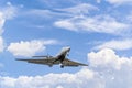Private business jet flying under a blue sky Royalty Free Stock Photo