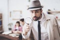 Private detective agency. Man is posing with magnifying glass, woman is holding her daughter. Royalty Free Stock Photo