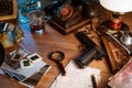 Private detective`s desk, noir still life with a vintage phone, typewriter, lamp, gun and retro photos Royalty Free Stock Photo