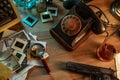 Private detective`s desk, noir still life with a vintage phone, typewriter, lamp, gun and retro photos Royalty Free Stock Photo