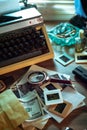 Private detective`s desk, noir still life with a vintage phone, typewriter, lamp, gun and retro photos Royalty Free Stock Photo