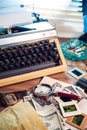 Private detective`s desk, noir still life with a vintage phone, typewriter, lamp, gun and retro photos Royalty Free Stock Photo