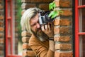 Private detective. SLR camera. hipster man with beard use professional camera. photographer hold retro camera