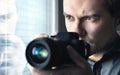 Private detective, undercover cop, investigator, spy or paparazzi with camera taking photos. Agent or police spying, investigating Royalty Free Stock Photo