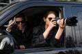 Private detectives with modern camera spying from car