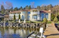 Private dock with jet ski lifts and covered boat lift, Lake Washington. Royalty Free Stock Photo