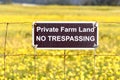 Private Farm Land No Trespassing sign posted on a barbed wire fence Royalty Free Stock Photo