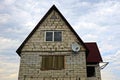 Gray brick house with window and satellite dish on the sky background Royalty Free Stock Photo