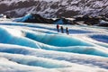 Private guide and couple of hiker walking on glacier at Solheimajokull