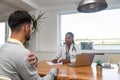 Private home doctor office female healthcare medical worker work with sick male patient. Ill young man talking with medic health Royalty Free Stock Photo