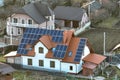 Private home roof covered with solar photovoltaic panels for generating of clean ecological electric energy in suburban