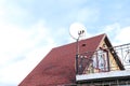 private house with tile rooftop, satellite dish antennas.Wireless television broadcasting reciever.