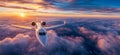 Private jet airplane flying above clouds in sunset Royalty Free Stock Photo