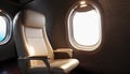 Private jet airplane interior with comfortable leather seat next to window