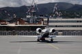 private jet airplane parked at outside in Genoa airport and waiting business persons. Luxury tourism and business travel Royalty Free Stock Photo