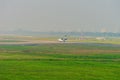 Private jet on blue sky. Business jet. Luxury twin engine plane fly over urban areas preparing landing Royalty Free Stock Photo