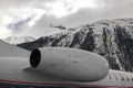 A private jet and a flying helicopter at the airport of St Moritz Royalty Free Stock Photo