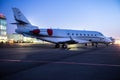 Private jet plane parking at the airport. Private airplane at sunrise. Early morning at airport apron.