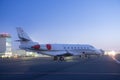 Private jet plane parking at the airport. Private airplane at sunrise. Early morning at airport apron.