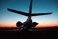 Private jet plane parking at the airport. Private airplane at sunrise. Early morning at airport apron.