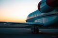 Private jet plane parking at the airport. Private airplane at sunrise. Early morning at airport apron.