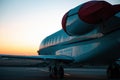 Private jet plane parking at the airport. Private airplane at sunrise. Early morning at airport apron.