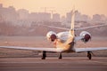 Private jet plane parking at the airport. Private airplane at sunrise. Early morning at airport apron.