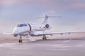 Private jet plane parking at the airport. Private airplane at sunset, Royalty Free Stock Photo