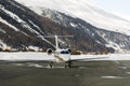 A private jet is ready to take off in the airport of St moritz in the alps switzerland in winter