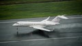 Private jet type Bombardier global 5000 landing on wet runway at