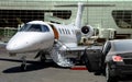 Private jet waiting for passenger with black limo in airport Royalty Free Stock Photo