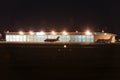 Private jets parked in front of hangar at nigt Royalty Free Stock Photo