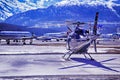 Private jets, planes and helicopters in the beautiful snow covered mountains of alps in St Moritz Switzerland Royalty Free Stock Photo