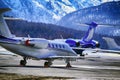 Private jets, planes and helicopters in the beautiful snow covered mountains of alps in St Moritz Switzerland