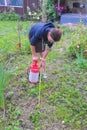 On private land the girl of the gardener processes trees and bus Royalty Free Stock Photo