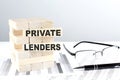 PRIVATE LENDERS is written on wooden blocks on a chart background