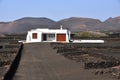 Private lonesome white bungalow in black volcanic lava landscape