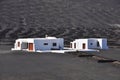 Private lonesome white bungalow in black volcanic lava landscape