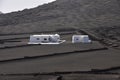 Private lonesome white bungalow in black volcanic lava landscape