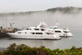 Private luxury yachts in fog