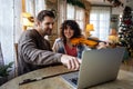 Private male music teacher giving violin lessons to a woman at home Royalty Free Stock Photo