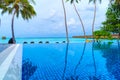 Private oceanfront pool with submerged loungers in a luxury reso