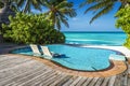 Private oceanfront pool with submerged loungers in a luxury resort