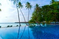 Private oceanfront pool with submerged loungers in a luxury reso