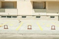 Private parking lot space for cars with reservation numbers in front of the residential building in the city and metal barriers lo Royalty Free Stock Photo