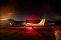 Private plane on airport parking ramp at night with sky full of stars