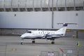 Private 2-prop plane parked next to an airport wall Royalty Free Stock Photo